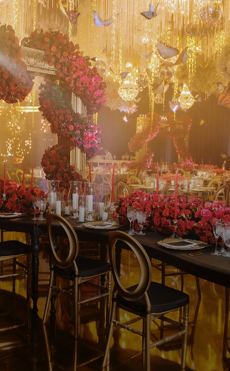 a room with tables and chairs with flowers on the wall