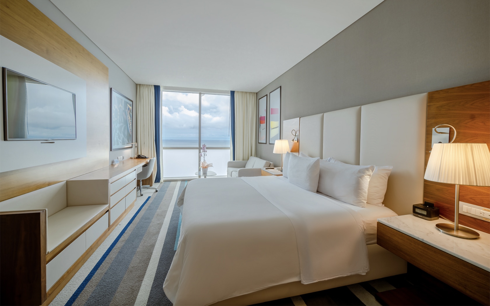 a hotel room with a bed and a desk