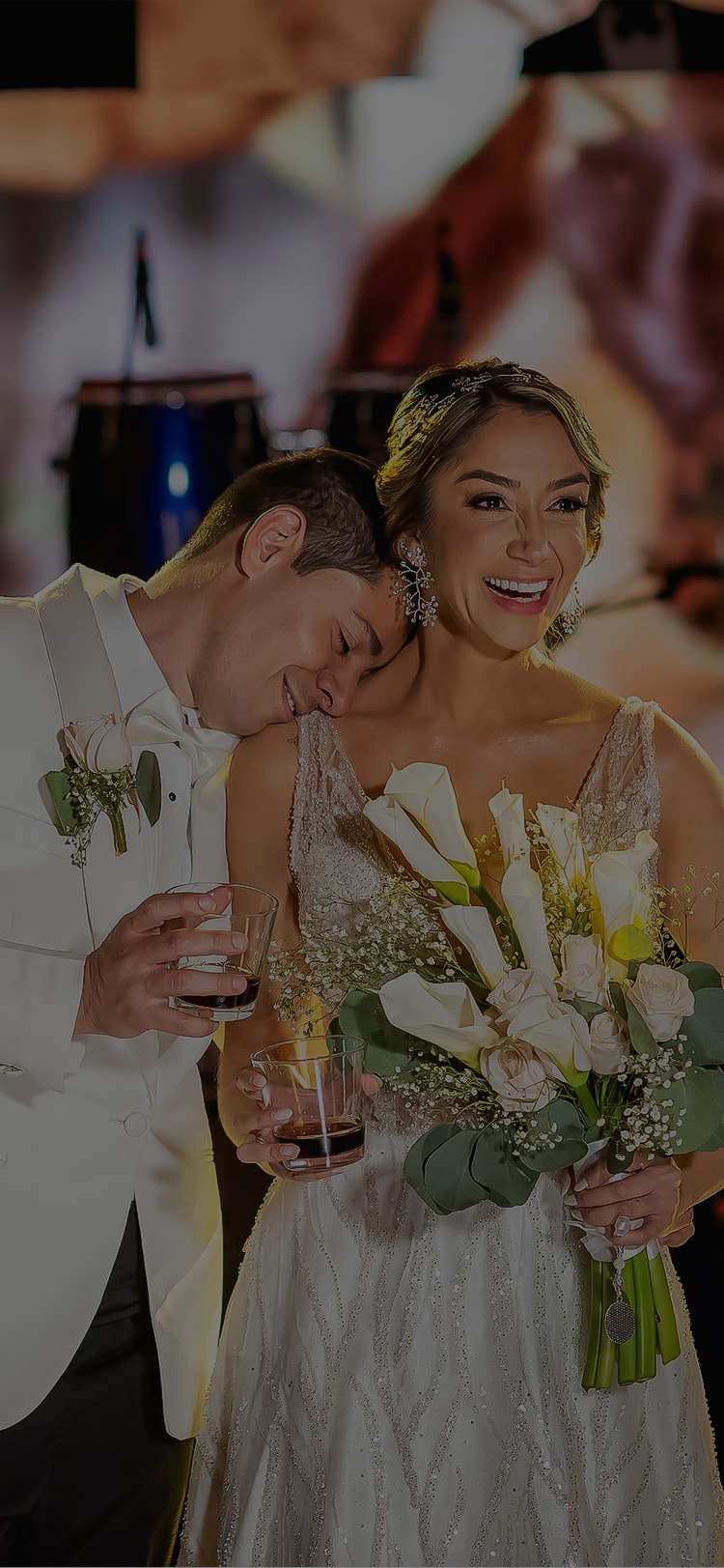 a man kissing a woman in a wedding dress
