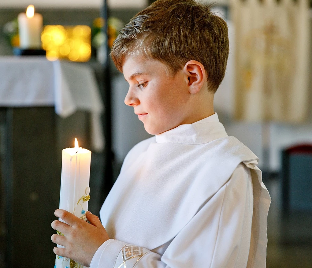 a person holding a lit candle