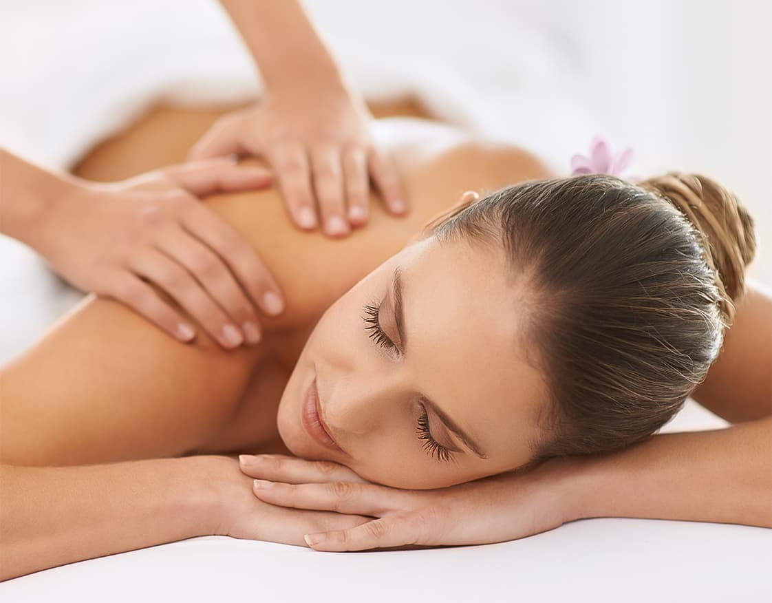 a woman lying on her back with her hands on her head