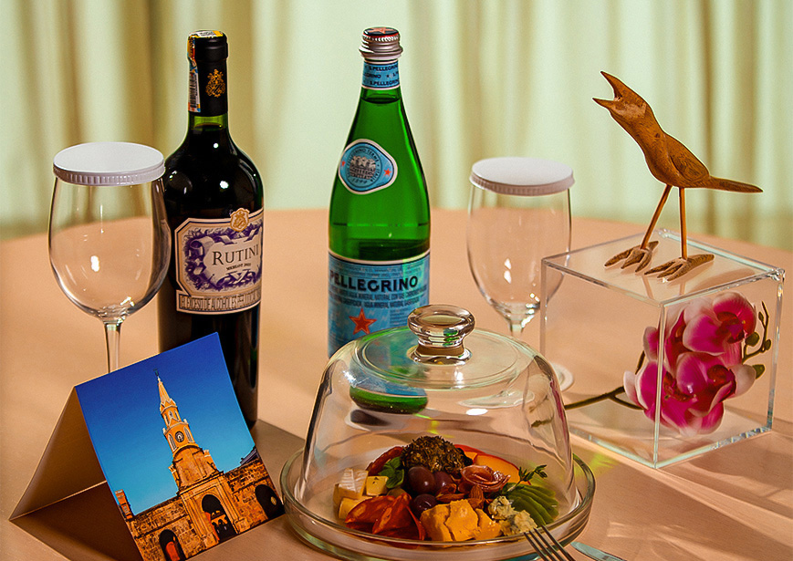 a table with wine bottles and a picture of a bird on it