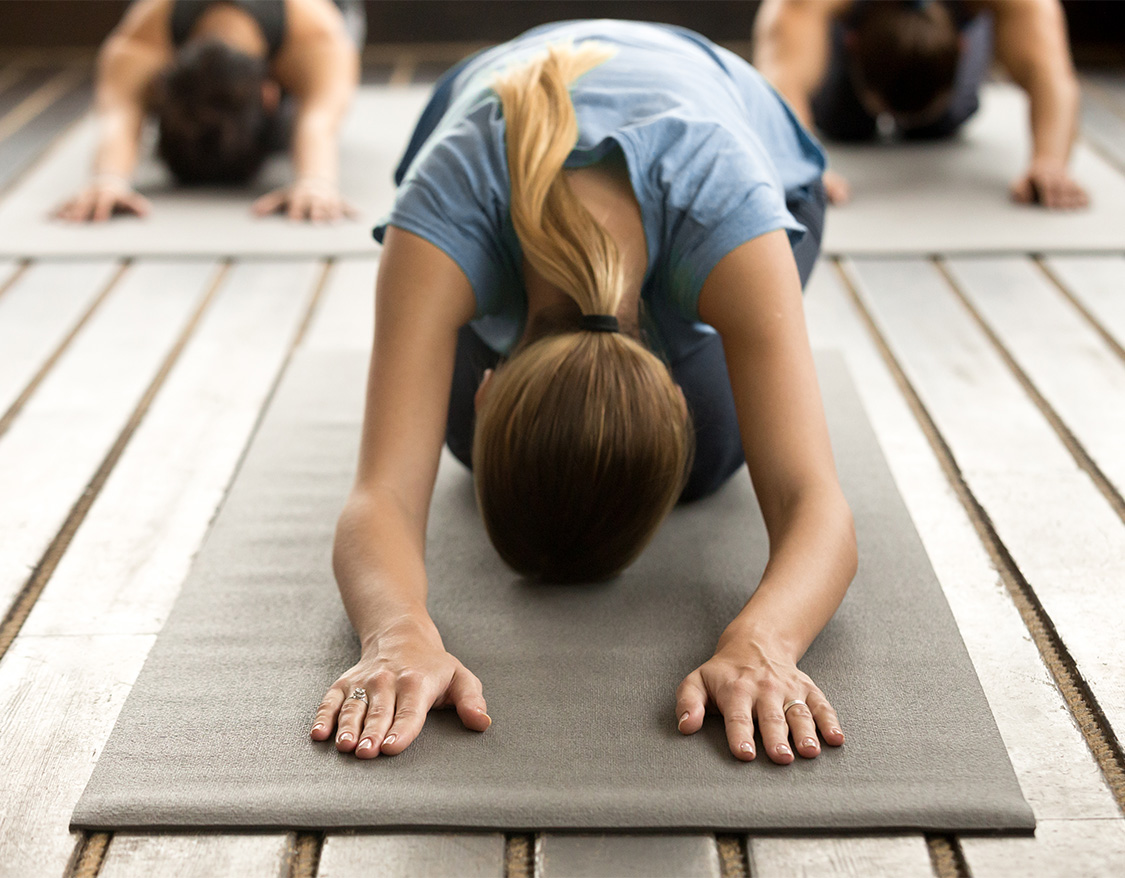 a woman doing yoga on a mat