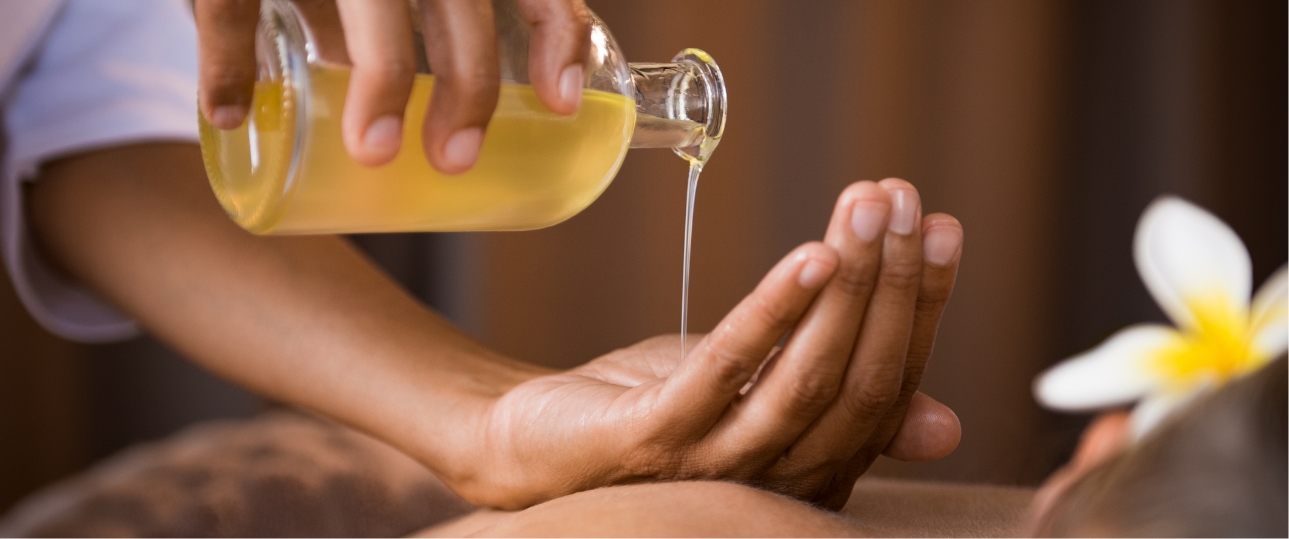 a person pouring a liquid onto a hand