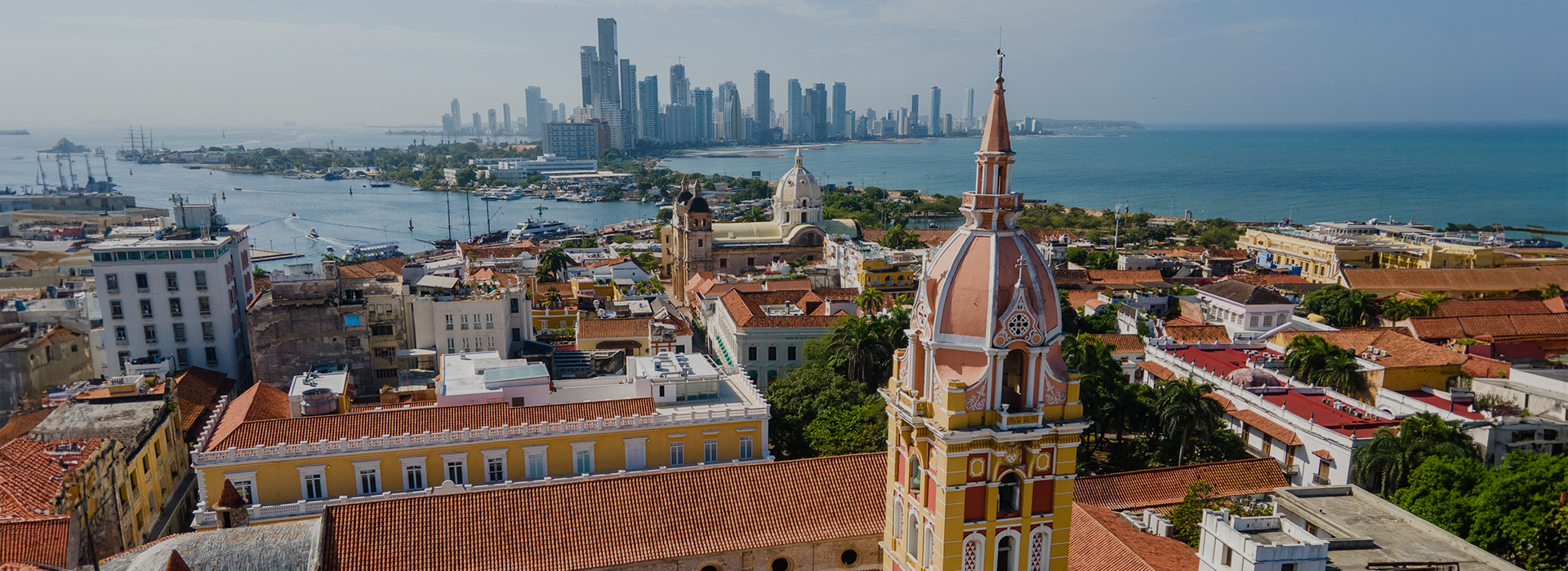 a city with a body of water and a city in the distance