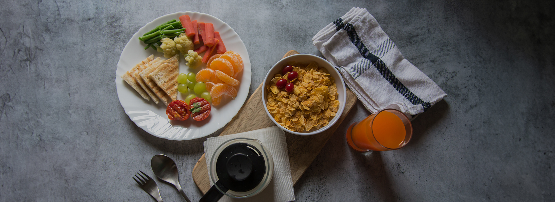 a plate of food and a glass of juice