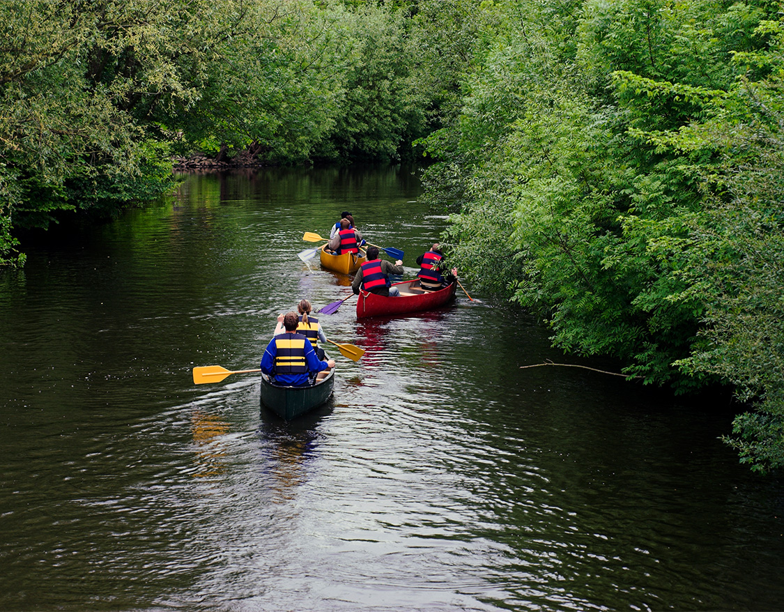 a group of people in canoes on a river