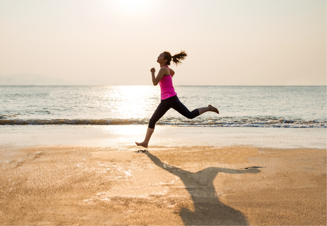 a woman running on a beach