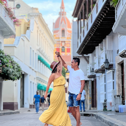 a man and woman dancing on a street