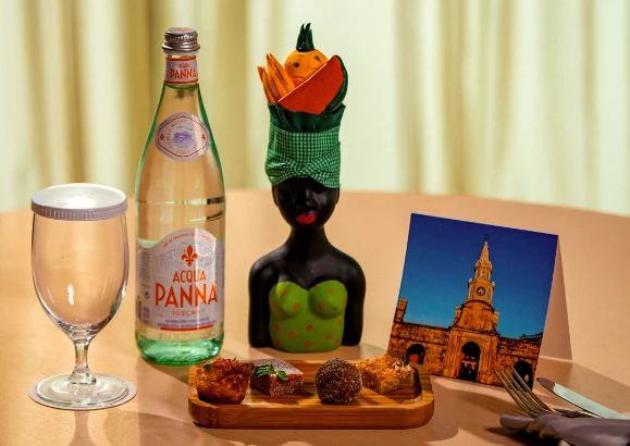 a bottle of water and a statue on a table