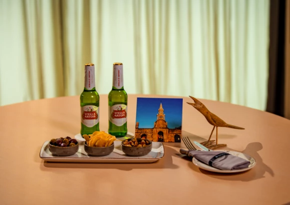 a table with a plate of food and a bird figure on it