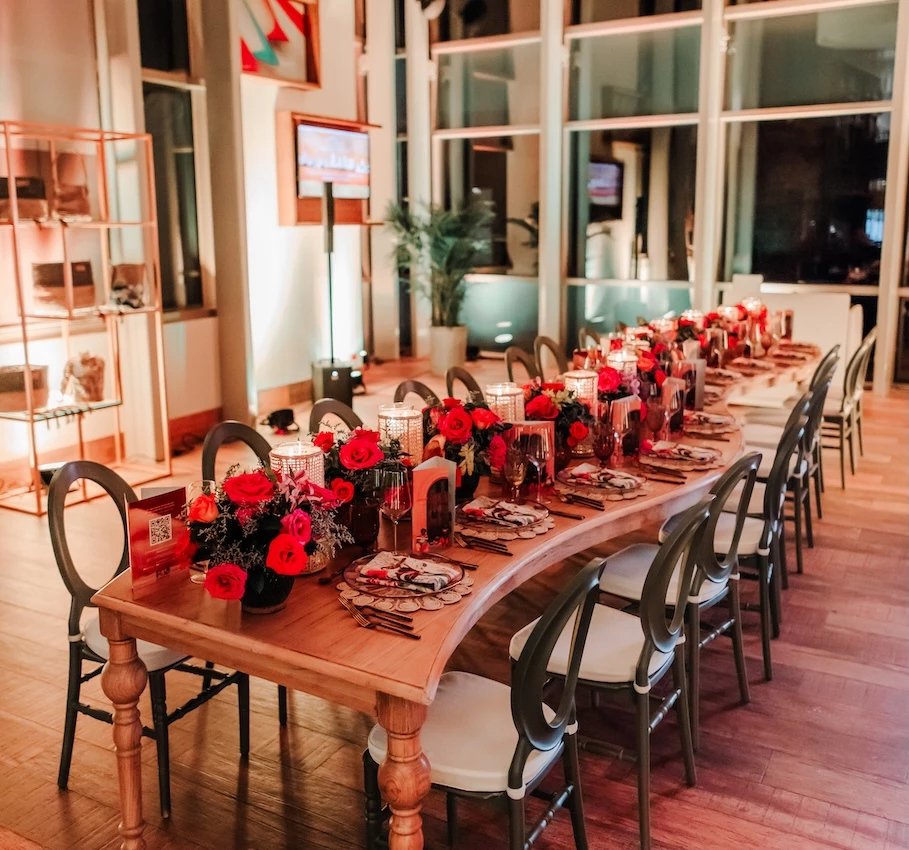 a long table with flowers and candles