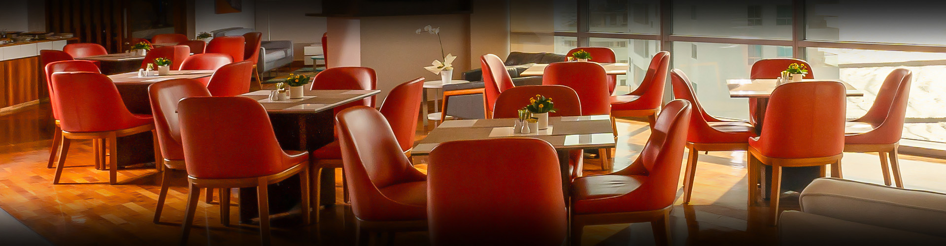 a room with red chairs and tables