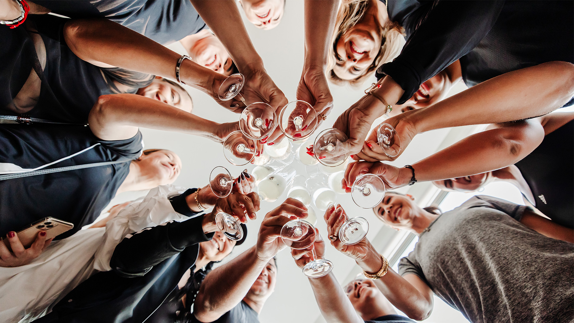 a group of people holding wine glasses