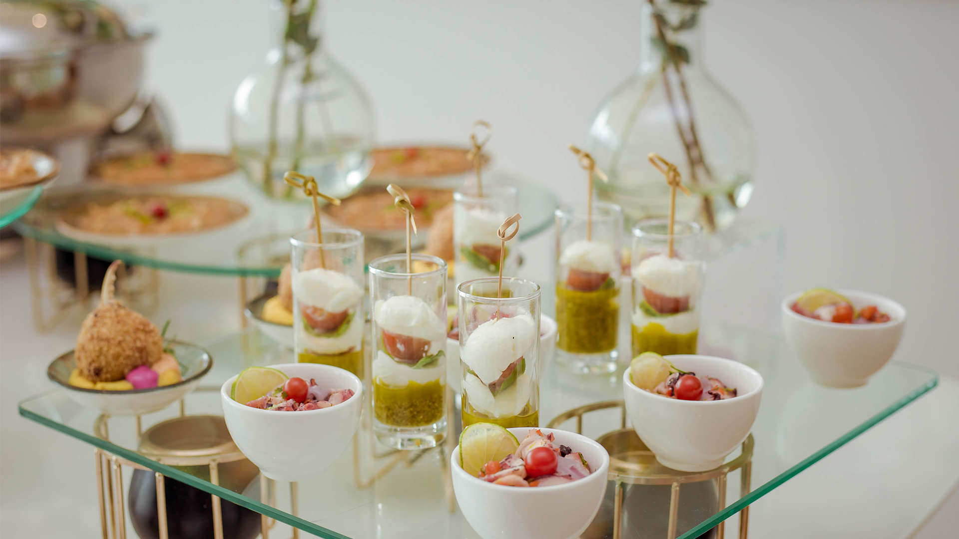 a group of small glasses filled with food