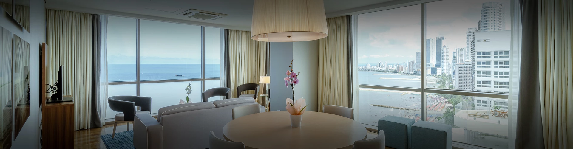 a room with a table and chairs and a lamp