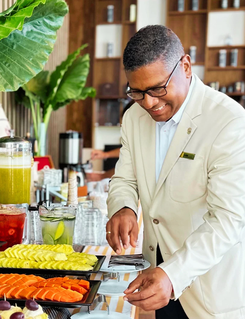 a man in a white suit catering an event