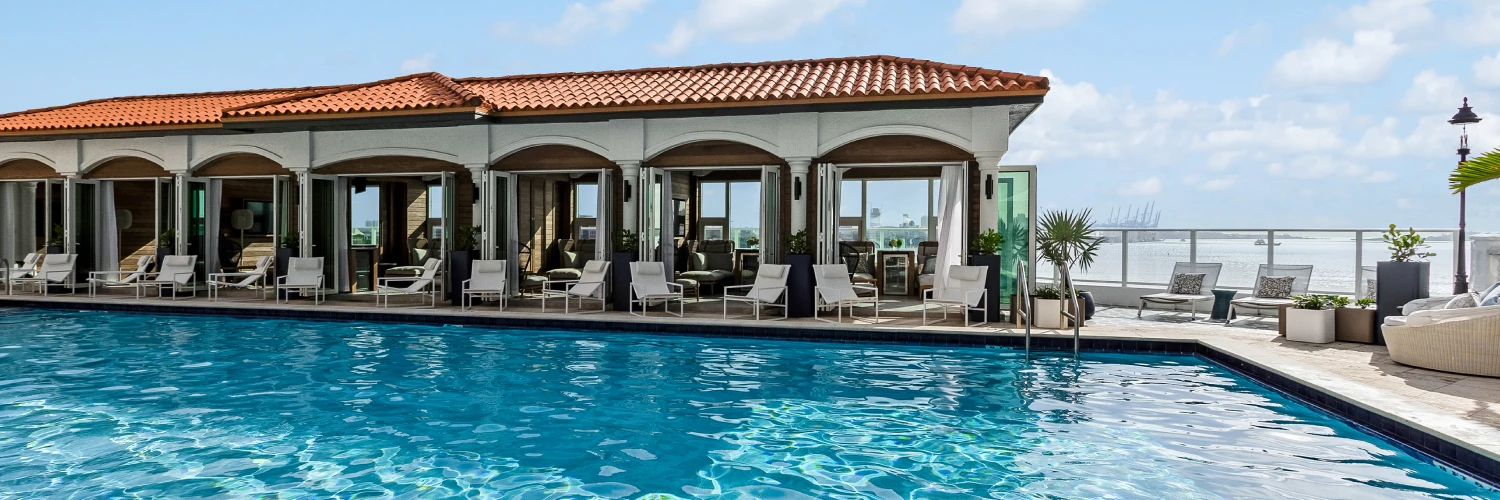 a swimming pool with chairs around it