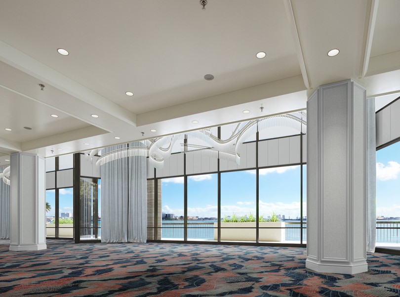 a room with large windows and a view of the water