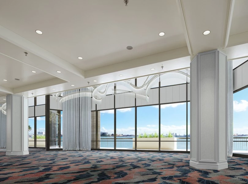 a room with large windows and a view of the water