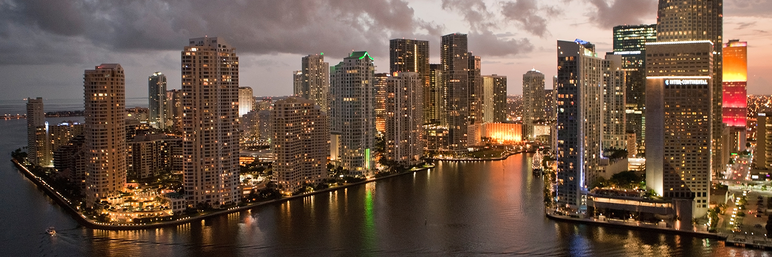 a city skyline with lights on the water