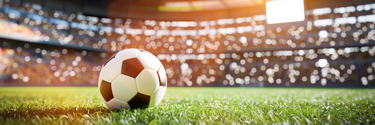 a football ball on grass in a stadium