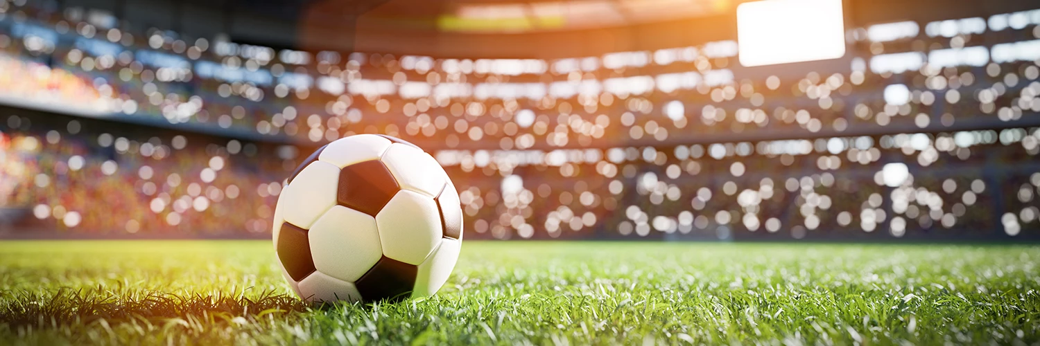 a football ball on grass in a stadium