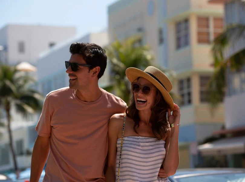 a couple laughing on a beach