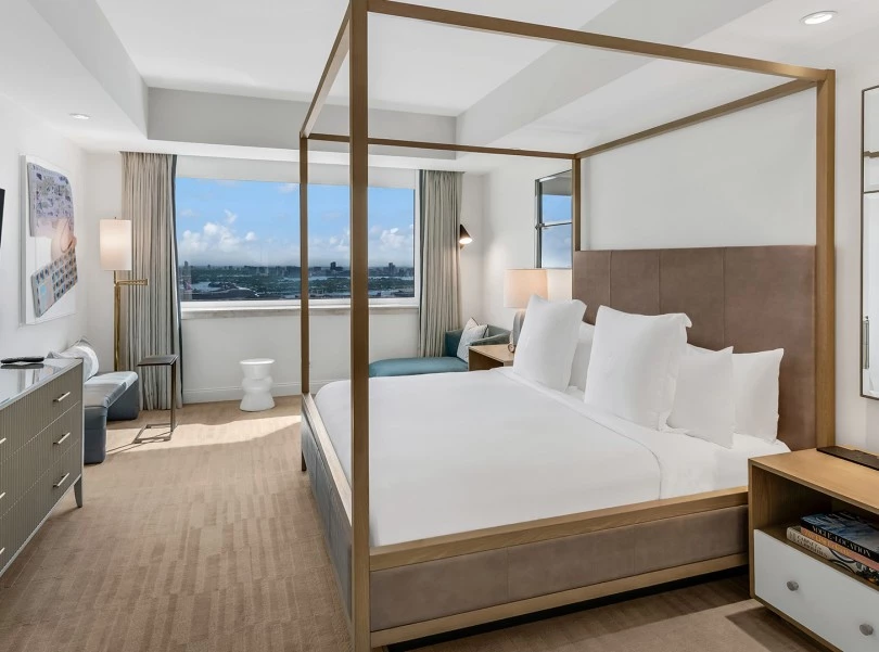 a bedroom with a four poster bed and a window