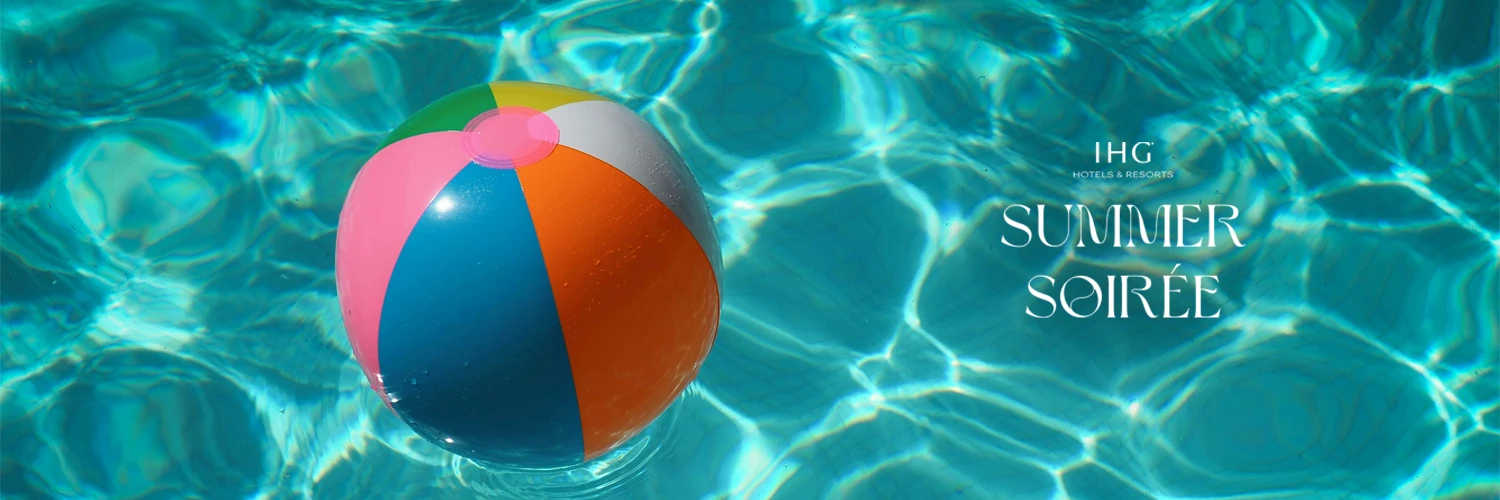 a colorful beach ball floating in a pool with summer soiree logo