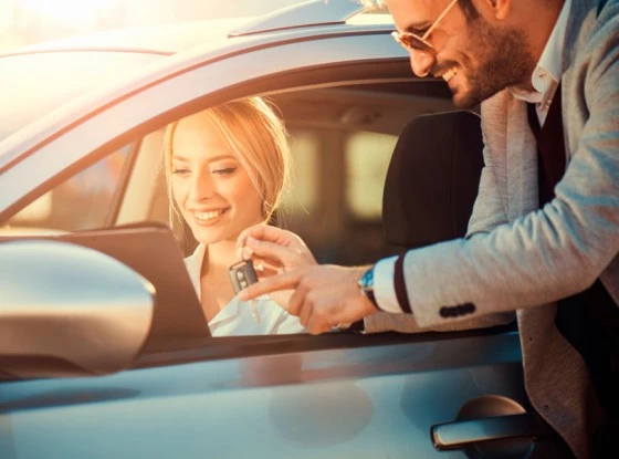 man leaning into car window