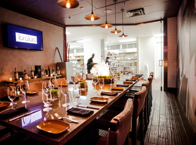 a long table with wine glasses and plates