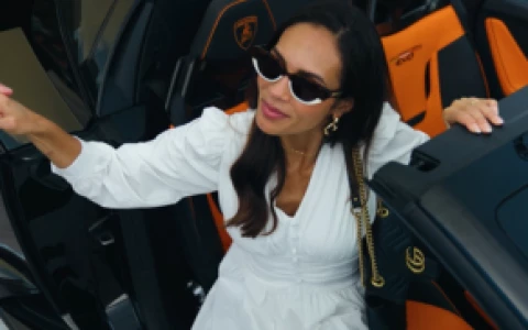 a woman in a white dress and sunglasses