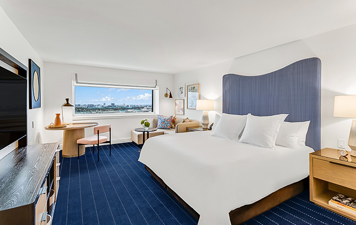 a room with a bed and a desk and chair