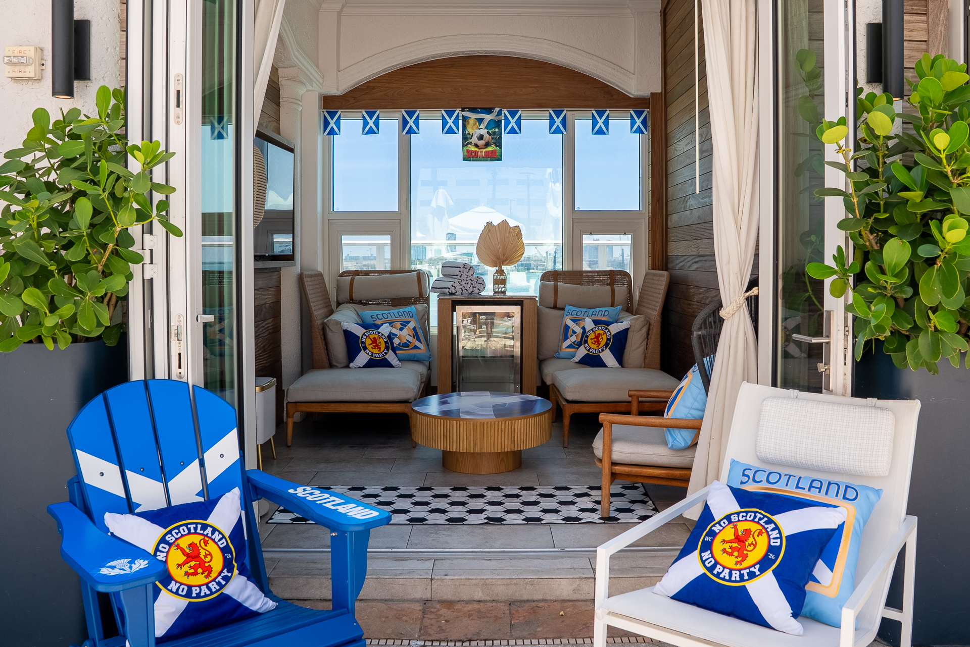 a patio with chairs and a table