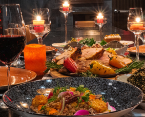 a table with food and wine glasses