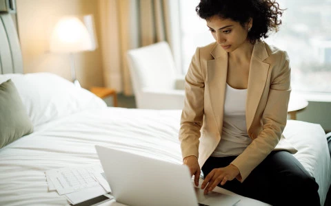 business woman checking emails in her guest room