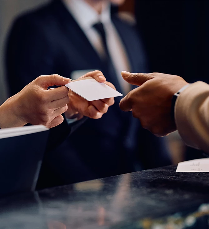 a person handing over a card to another person