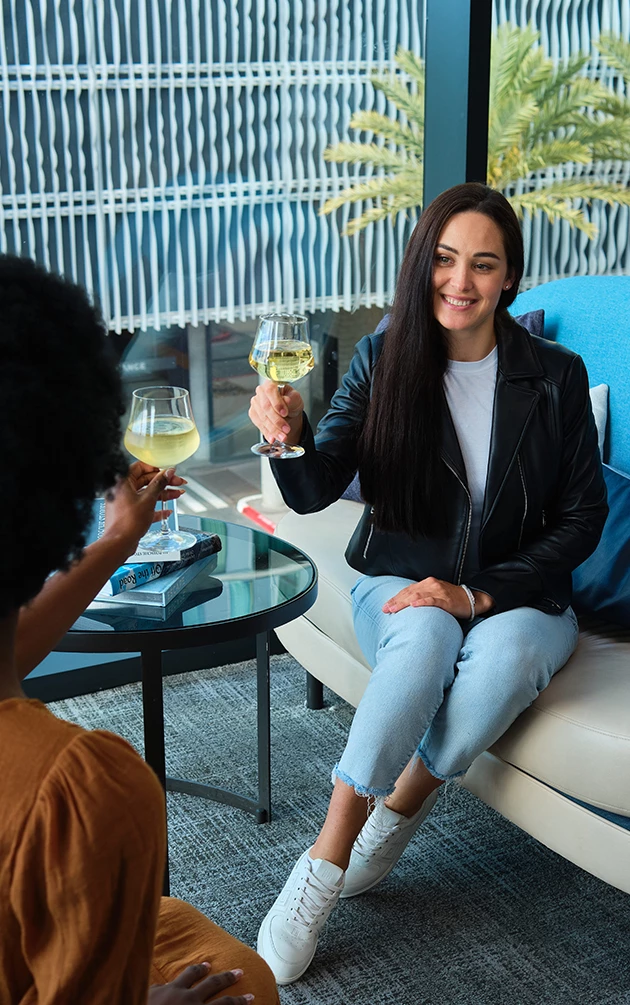 a woman holding wine glasses