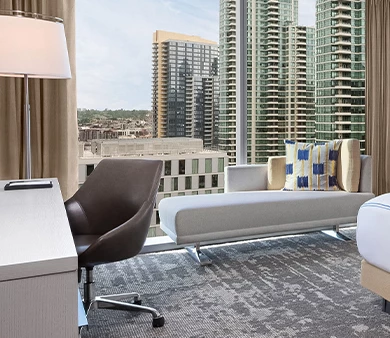 a room with a large window and a couch and a chair