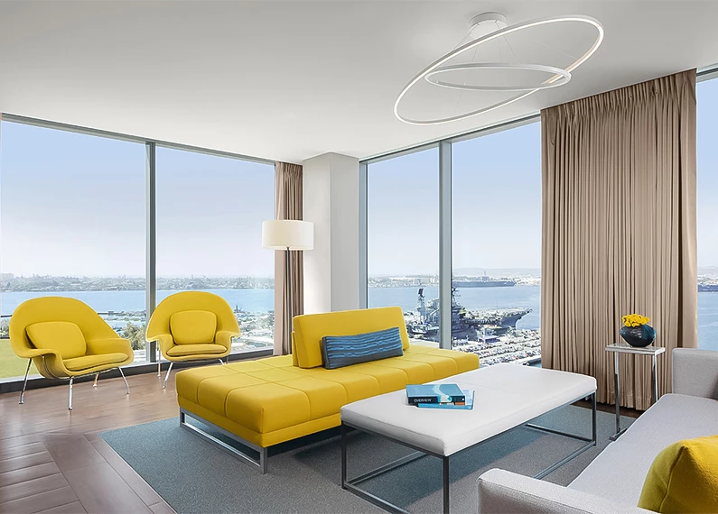 a room with yellow couches and chairs