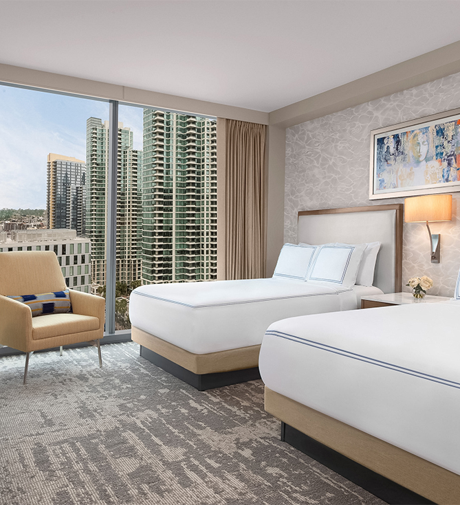 a room with two beds and a chair