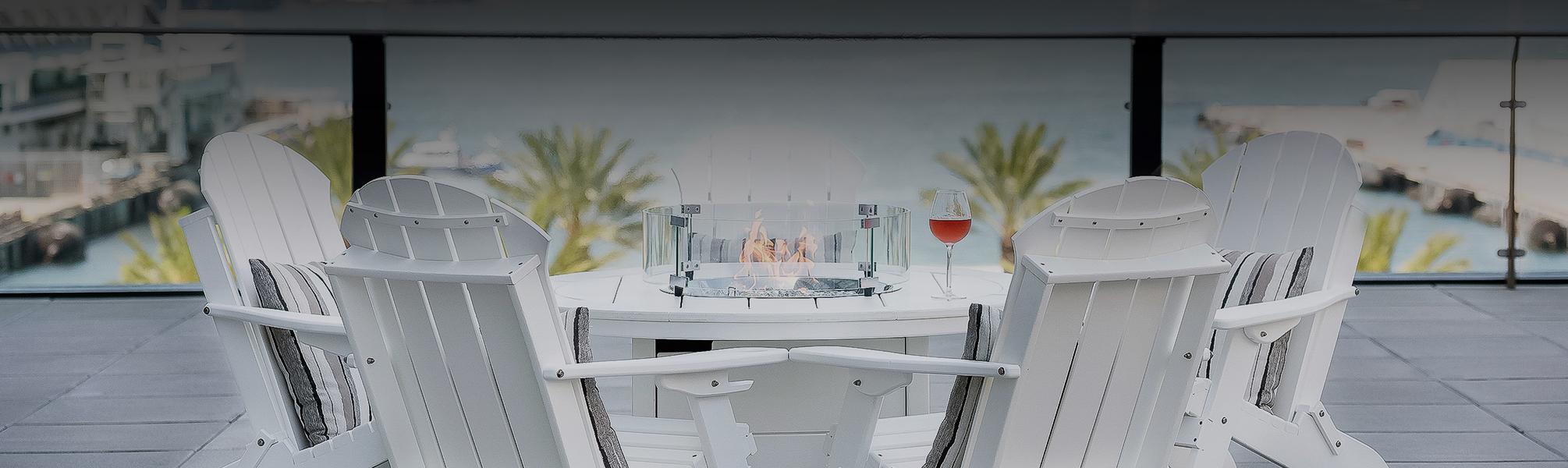 a fire pit with a glass of wine on a table