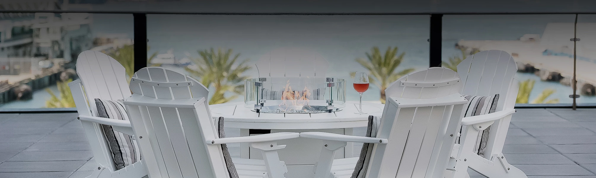 a fire pit with a glass of wine on a table