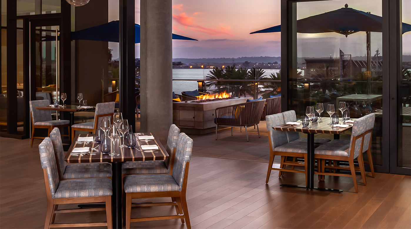 a restaurant with tables and chairs and a fire pit