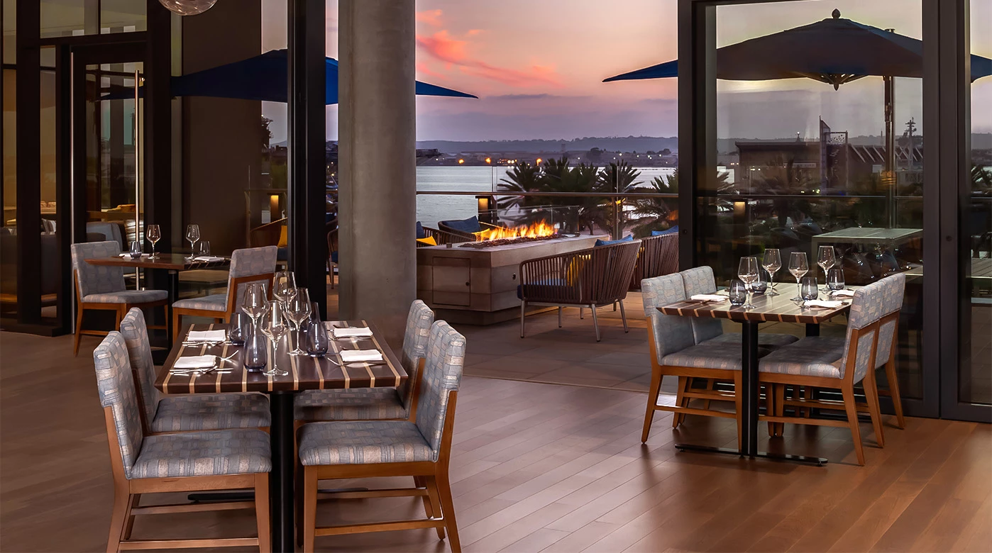 a restaurant with tables and chairs and a fire pit