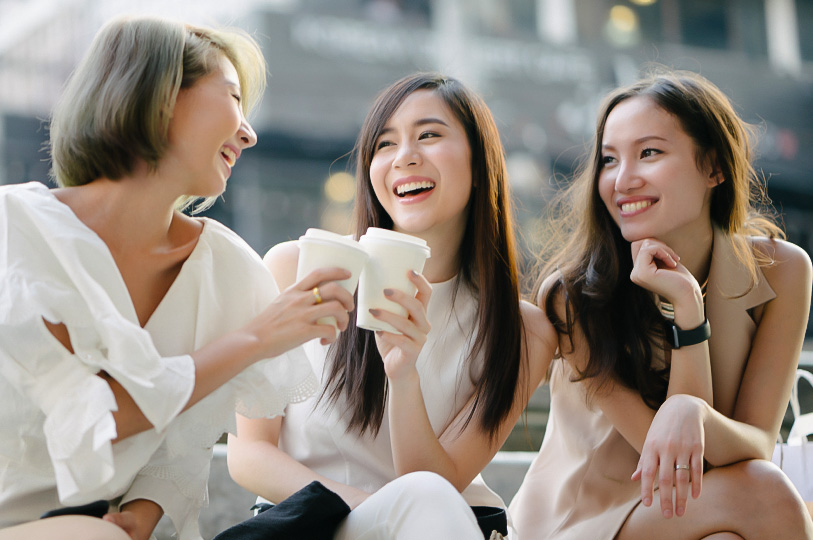a group of women sitting and laughing
