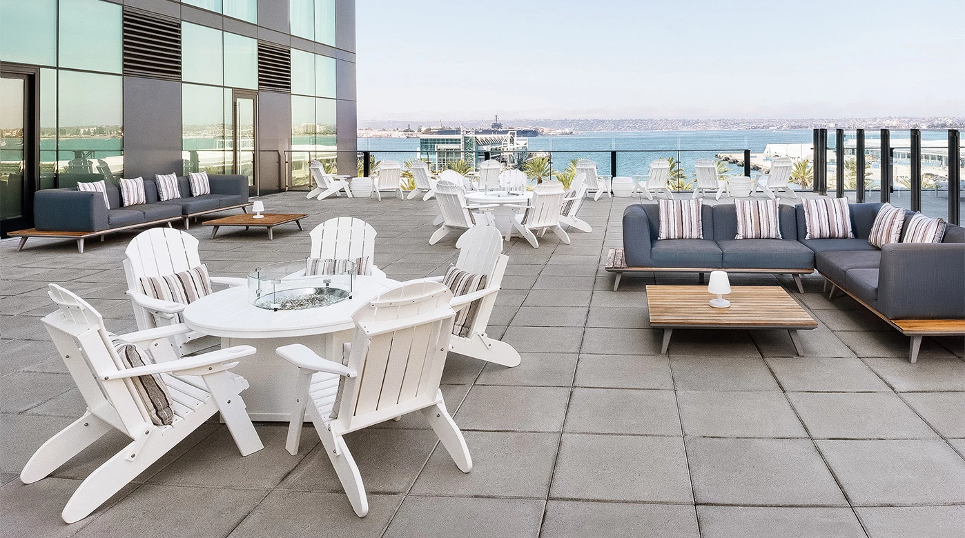 a patio with chairs and tables on a building