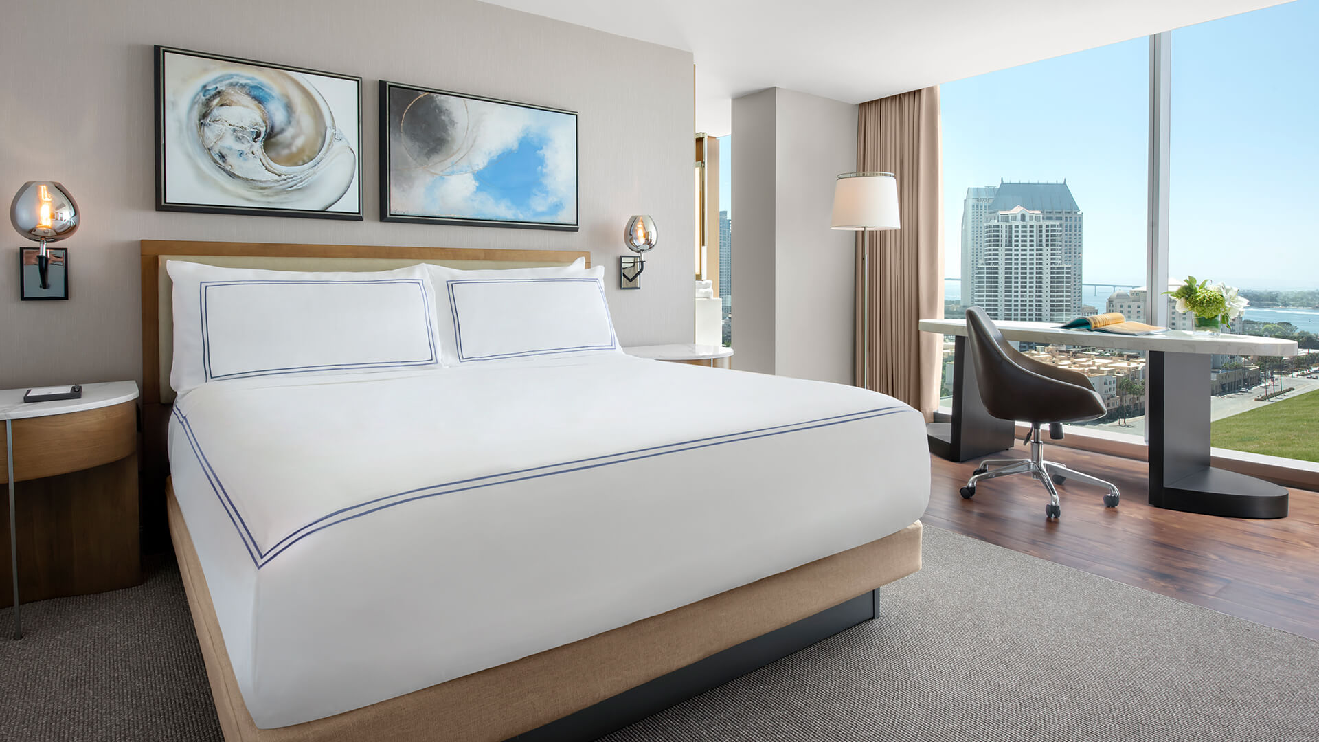 a hotel room with a large bed and a desk