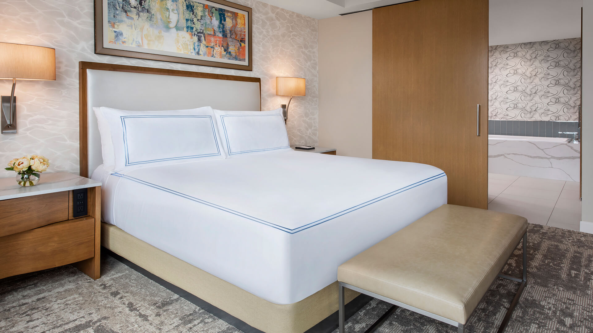 a bed with a lamp and a table